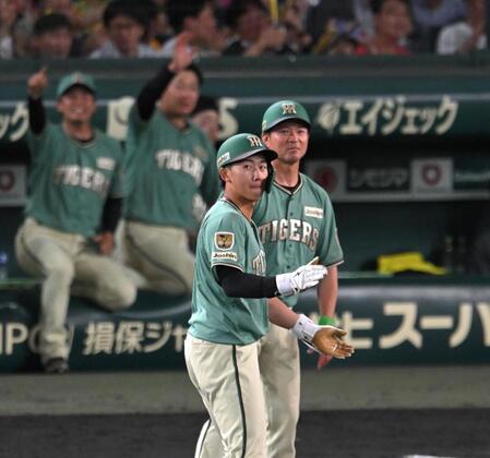 ６回、適時打を放ち、塁上で手を叩く立石（撮影・飯室逸平）