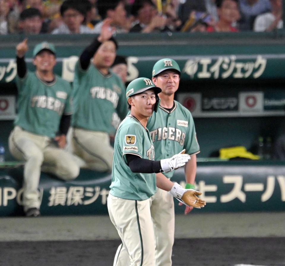 　６回、適時打を放ち、塁上で手を叩く立石（撮影・飯室逸平）