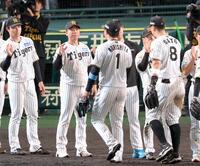 勝利のタッチを交わす村上（左から２人目）ら阪神ナイン（撮影・立川洋一郎）