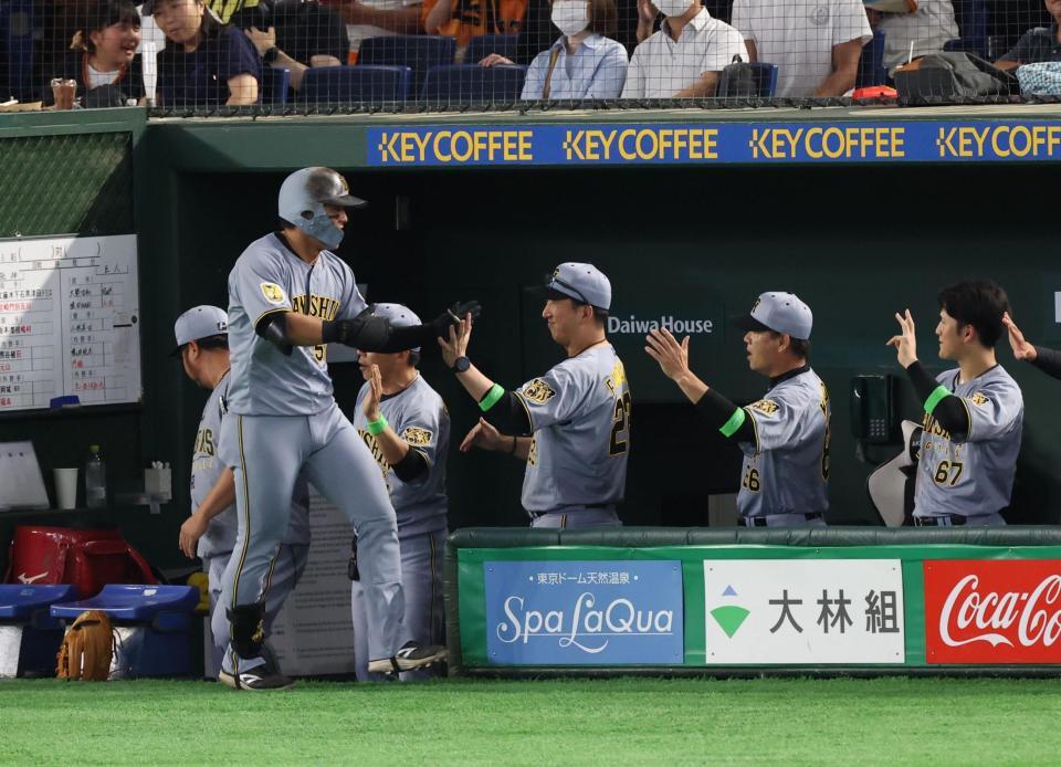 ７回、右越えソロを放った前川（左）を出迎える藤川監督（撮影・佐々木彰尚）