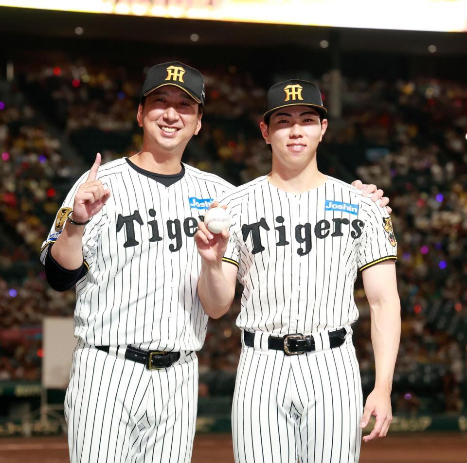 プロ初勝利を挙げ、藤川監督（左）と記念撮影をする工藤（撮影・西田忠信）