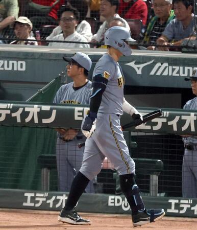 ８回、空振り三振に倒れベンチに戻る佐藤輝（左は藤川監督）＝撮影・山口登