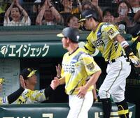 ６回、先制ソロを放った佐藤輝を迎える藤川監督（左）＝撮影・山口登