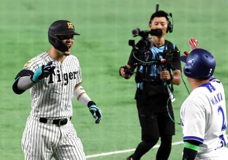 １回、先制ソロを放ち笑顔で生還する佐藤輝（左）＝撮影・山口登