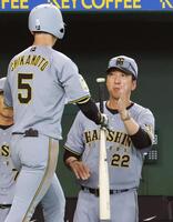 ３回表、先制ソロを放った近本（左）を迎える藤川監督