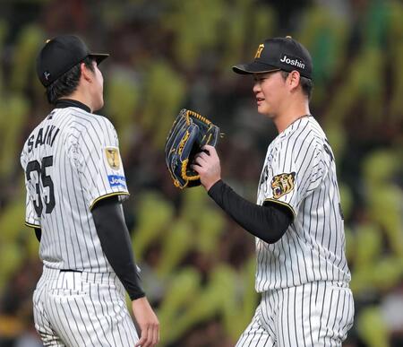 ７回を投げ終え、才木（左）に迎えられる及川（撮影・西田忠信）