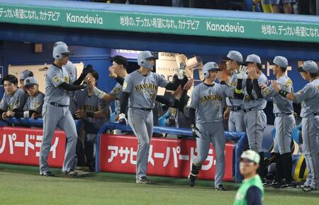 ７回、右越え３ランを放ちナインに迎えられる近本ら（撮影・金田祐二）