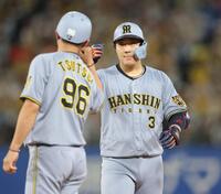 ９回、中前適時打を放ち、筒井コーチ（左）とタッチを交わす大山（撮影・西岡正）