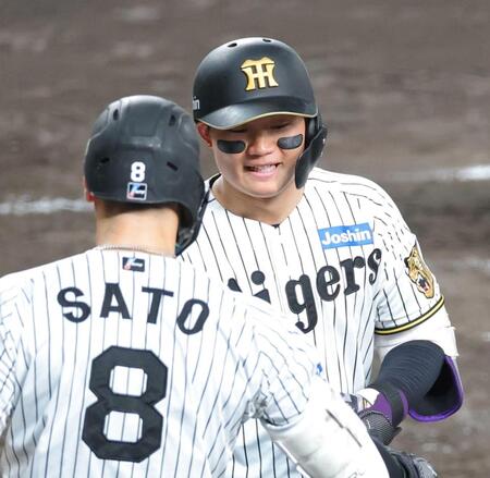 　ソロを放って生還し、迎える佐藤輝（８）に笑顔を見せる森下（撮影・立川洋一郎）