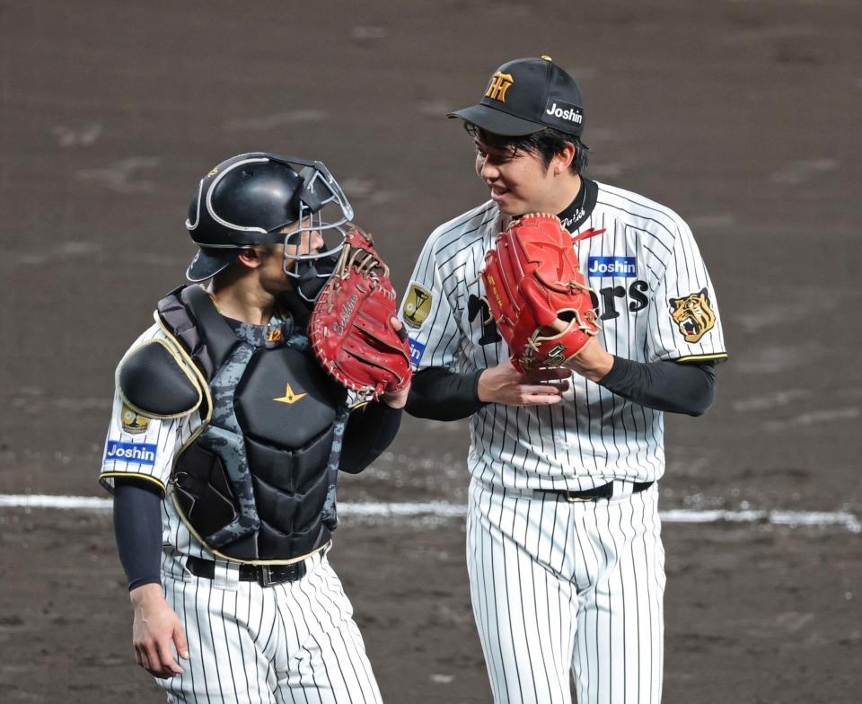 ５回、坂本（左）と言葉を交わしてベンチへ引き揚げる才木（撮影・立川洋一郎）