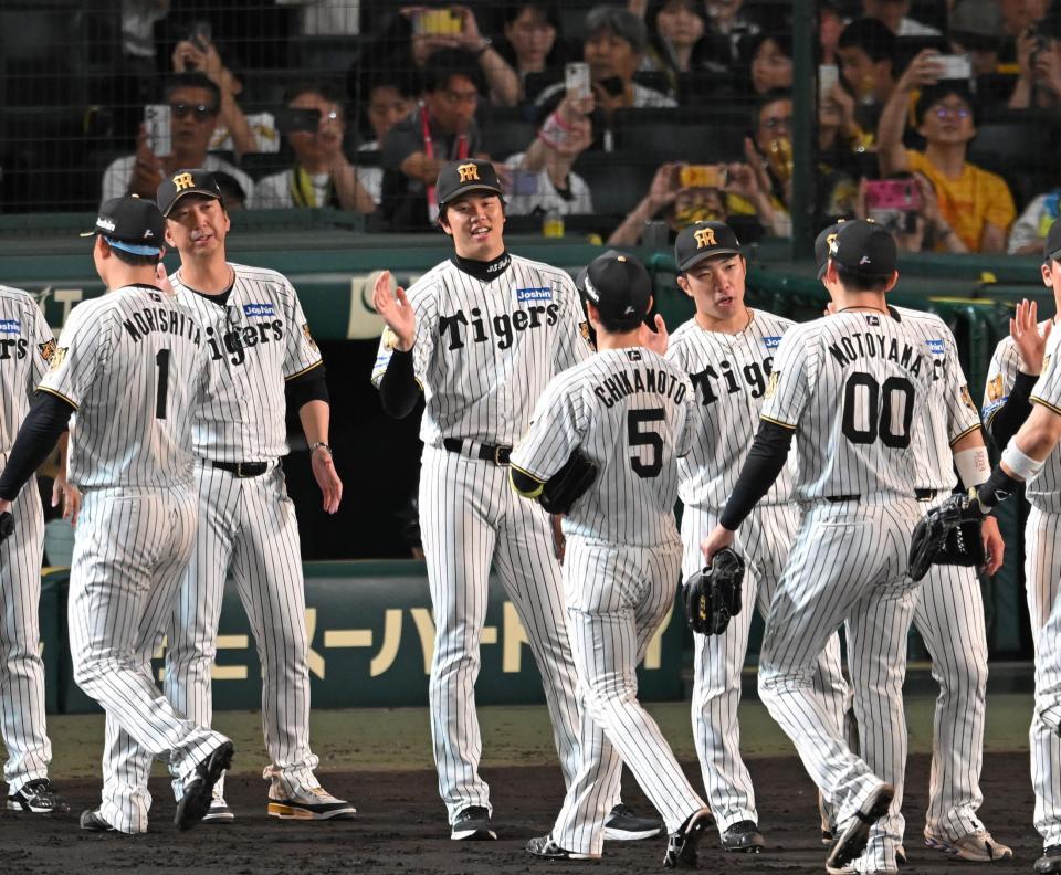笑顔で勝利のハイタッチを交わす才木ら阪神ナイン（撮影・飯室逸平）