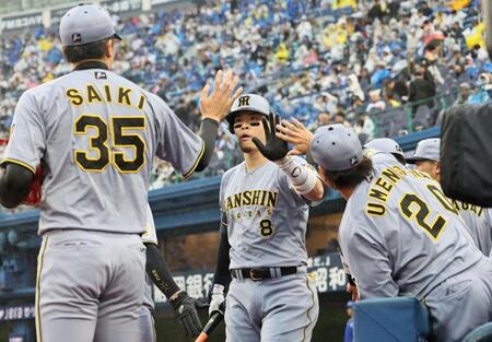 １回、先制犠飛を放った佐藤輝は才木とタッチを交わす（撮影・田中太一）