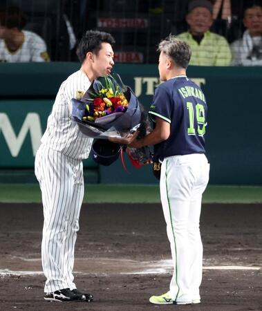 引退する石川に花束を贈る石井（左）＝撮影・山口登