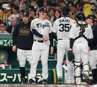 １回の守備を終えたナインを迎える佐藤輝（左）と森下（撮影・西田忠信）