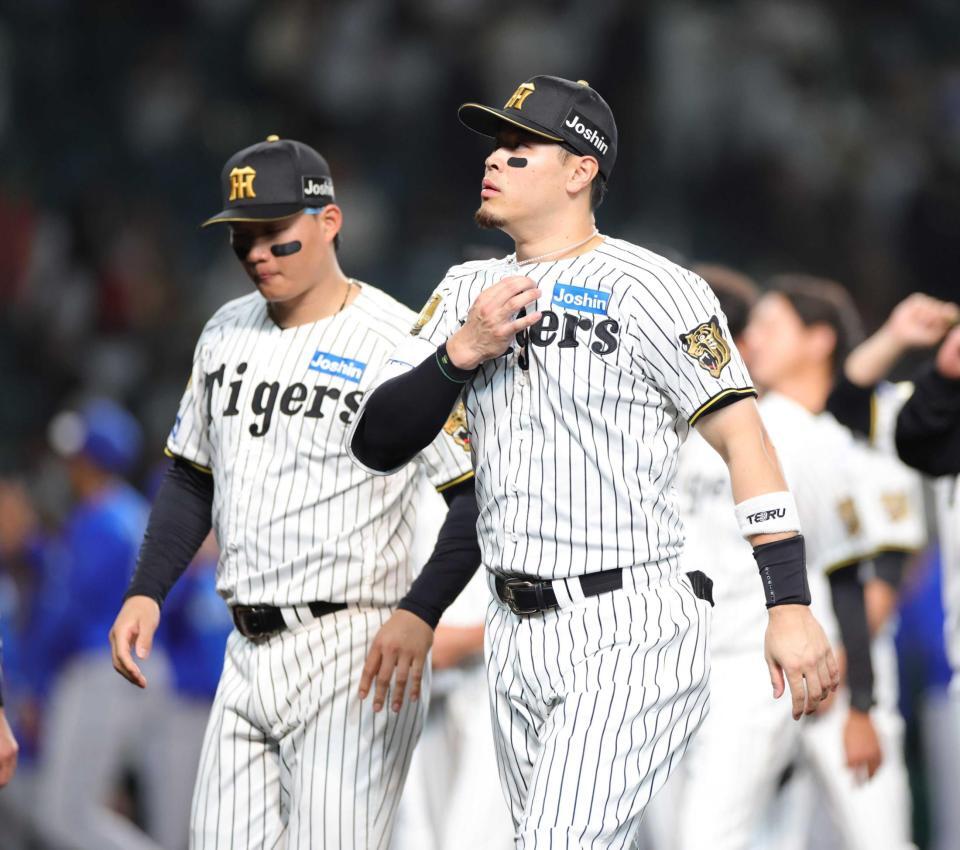 　ファンへのあいさつを終え、引き揚げる佐藤輝。左は森下（撮影・坂部計介）　