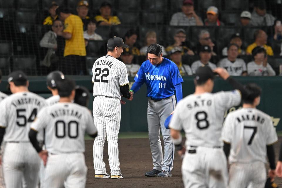 健闘をたたえ合い握手を交わす藤川監督と相川監督（撮影・飯室逸平）