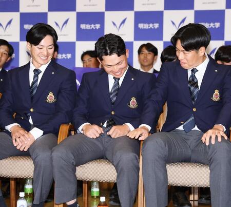 阪神から１位指名を受け、明大・松本直（右）と岡田啓吾（左）から祝福され、安どの表情を見せる榊原七斗（撮影・中島達哉）