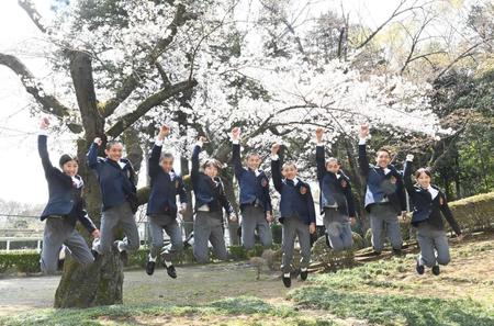 　桜の下でジャンプする（左から）萱野花音さん、川原謙心君、竹島英騎君、田中美海さん、谷原圭大君、千引陸君、藤田悠輔君、幸大斗君、山田仁菜さん