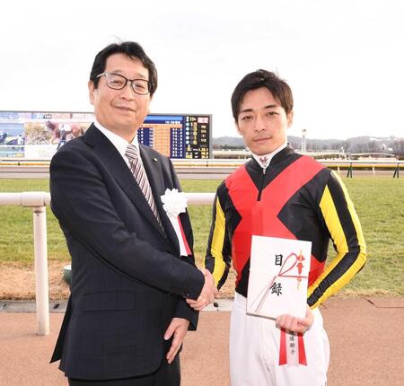 　握手をかわす永井英次デイリースポーツ東京代表（左）と川田将雅騎手＝東京競馬場（撮影・園田高夫）