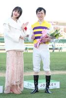 　ニシノデイジーで中山大障害を勝利し、ゲストプレゼンターの岡田紗佳（左）と記念撮影におさまる五十嵐