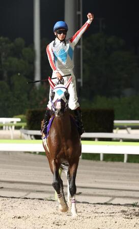 　観衆に向かってガッツポーズする横山武