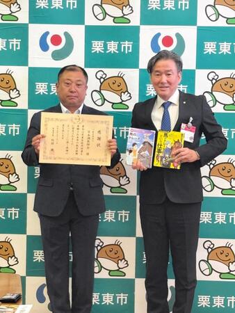 　図書寄贈式に出席した高橋義忠調教師（左）と栗東市・竹村健市長