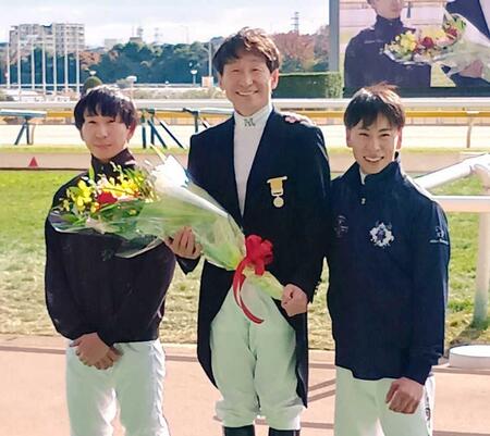 　黄綬褒章受章記念セレモニーに臨んだ横山典（中）に花束を贈呈した息子の和生（左）と武史