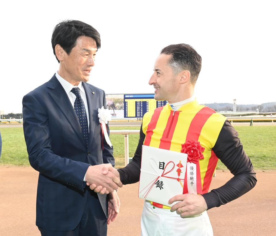 クリストフ・ルメール騎手（右）を祝福するデイリースポーツ・秦ビジネス局長＝東京競馬場（撮影・園田高夫）